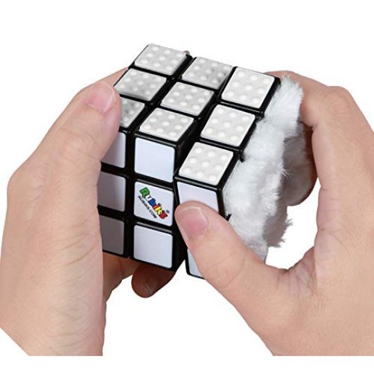 all-white rubik's cube in hand